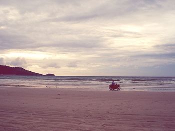 Scenic view of sea against cloudy sky