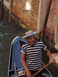 Portrait of man standing in boat