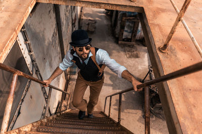 Full length of man standing on staircase