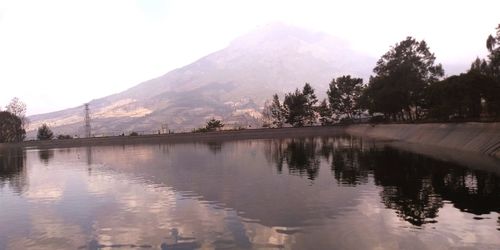 Scenic view of lake and mountains against sky