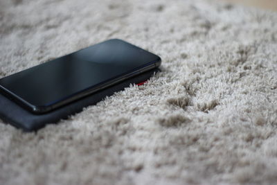 Close-up of smart phone on rug