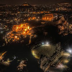 High angle view of illuminated buildings in city at night