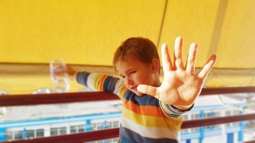 Cute boy showing stop gesture