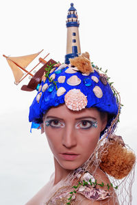 Portrait of young woman with make-up against white background