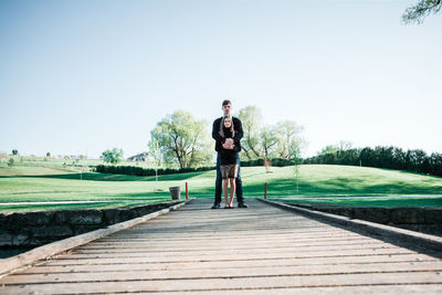 Full length portrait of man standing against sky