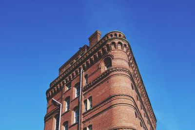 Low angle view of tower against blue sky