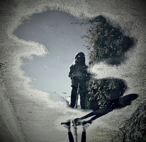 High angle view of people standing on puddle