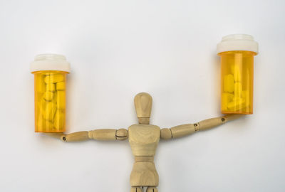 High angle view of bottles on table against white background