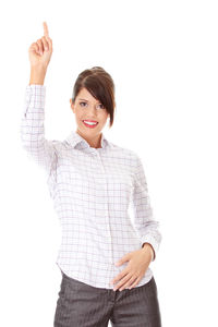 Portrait of smiling young woman standing against white background