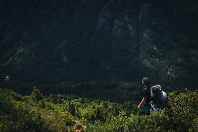 High angle view of hiker looking at mountain