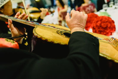 Cropped image of man playing guitar