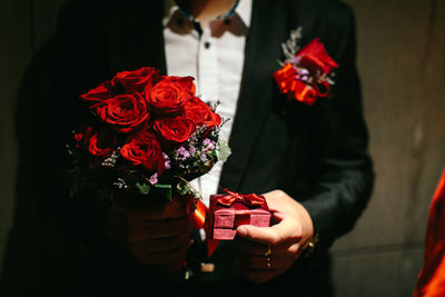 Close-up of red rose holding bouquet