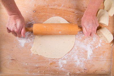 Close-up of person preparing food on cutting board