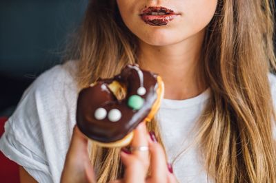 Close-up of young woman with ice cream