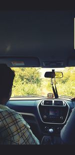 Rear view of man driving car