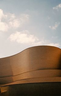 Low angle view of building against cloudy sky