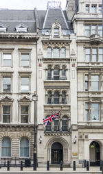 British architecture in parliament street, london with union jack flag flying.