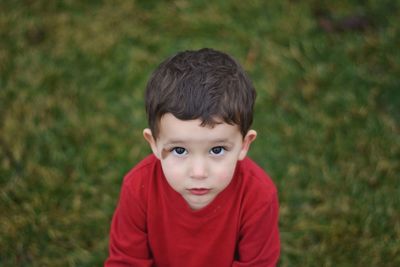 Close-up portrait of innocent boy on field