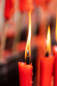 Close-up of lit candles in temple