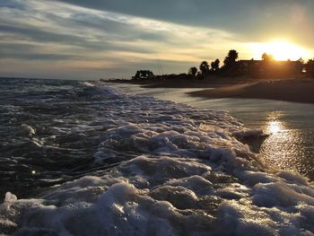 View of sea against cloudy sky during sunset