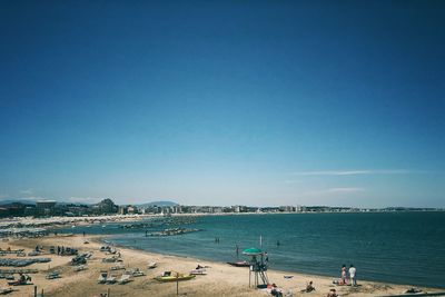 Scenic view of beach against clear blue sky