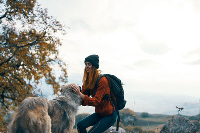 Man with dog against sky