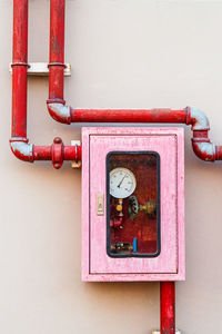 Close-up of telephone booth against wall