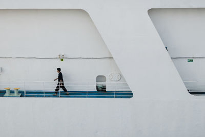 Side view of man walking on ship