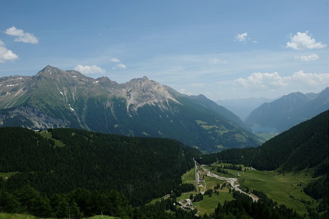 mountain, mountain range, scenics, tranquil scene, tranquility, landscape, beauty in nature, sky, nature, non-urban scene, valley, tree, cloud - sky, green color, idyllic, high angle view, cloud, day, remote, outdoors