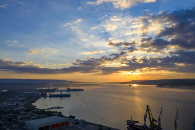 High angle view of harbor against sky during sunset