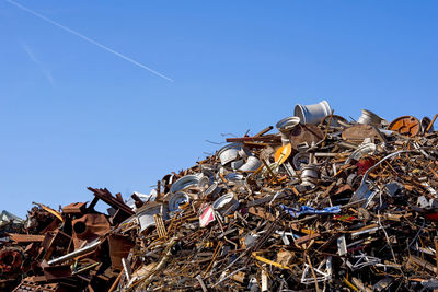 Scrap metals against clear blue sky