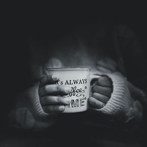 Close-up of hand holding coffee cup