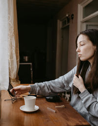 Young woman using mobile phone at home