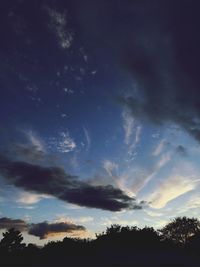 Low angle view of silhouette trees against sky at sunset