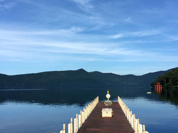 Pier over lake against sky