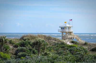 Lifeguard hut on beach against sky