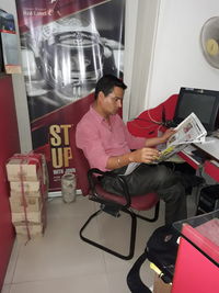 Man sitting on chair at home