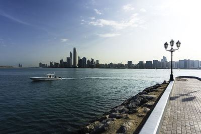 Scenic view of sea by buildings against sky