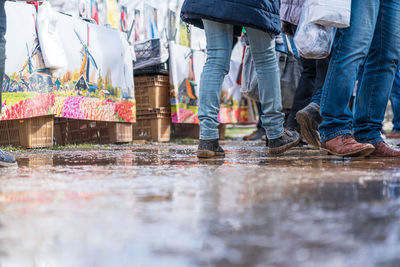 Low section of people walking on street