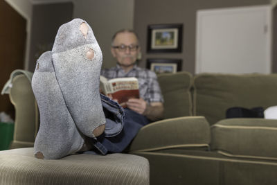 Man sitting on sofa at home