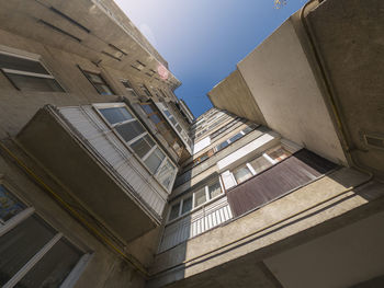 Corner of apartment building, balconies, view upwards