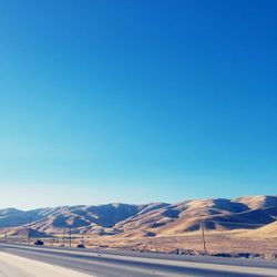 Scenic view of mountains against clear blue sky