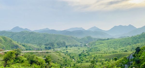 Scenic view of landscape and mountains against sky