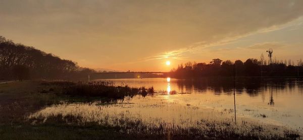 Scenic view of lake against sky during sunset