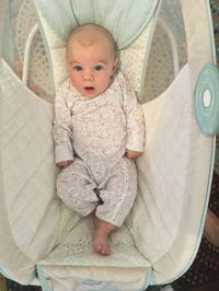 Portrait of cute baby boy on bed