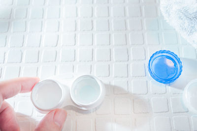 High angle view of human hand holding paper