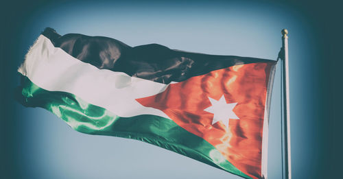 Low angle view of flag against clear sky