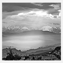 Scenic view of mountains against cloudy sky