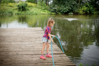 Rear view of woman standing in lake