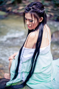 Beautiful young woman standing in sea